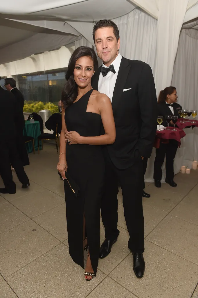 Liz Cho and Josh Elliott posing together in formal wear.