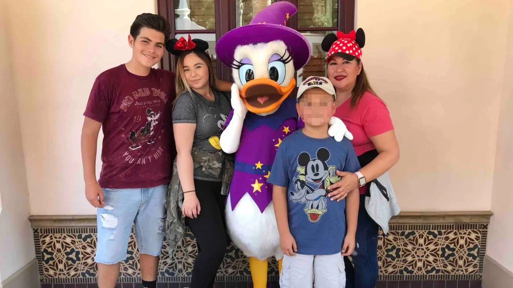 Christopher Garcia with family members and Daisy Duck.