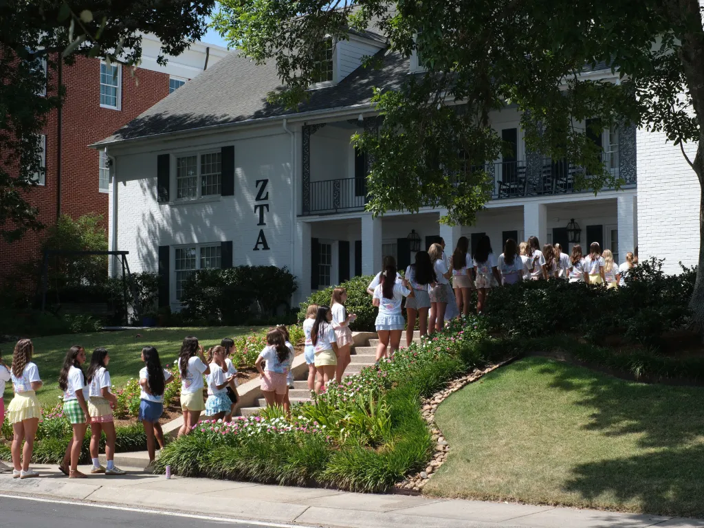 Hundreds of sorority hopefuls ascend the steps to a ZTA sorority house during Rush Week at Louisiana State University.