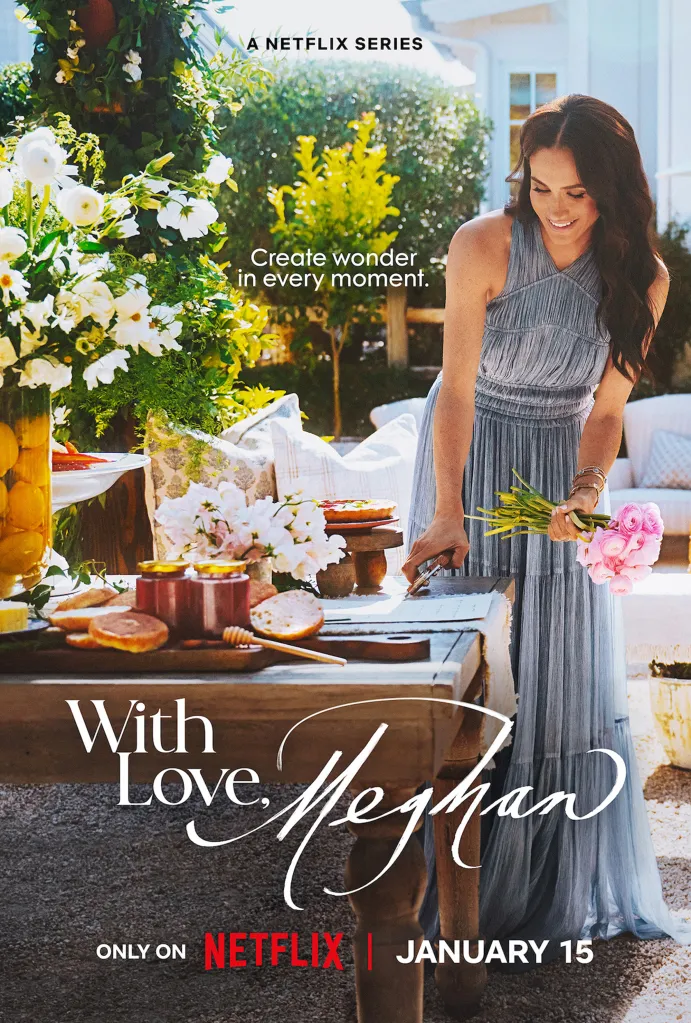 Meghan Markle arranging flowers and food on an outdoor table for 