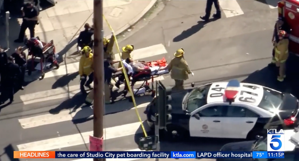 Emergency responders aid Cristina Vargas, 81, on a stretcher after an impaired driver crashed into her outside a Boyle Heights restaurant.