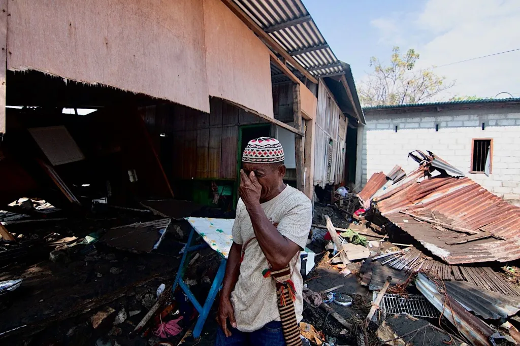 A man cries as he inspects the damage to his family home on Aug. 15, 2026.