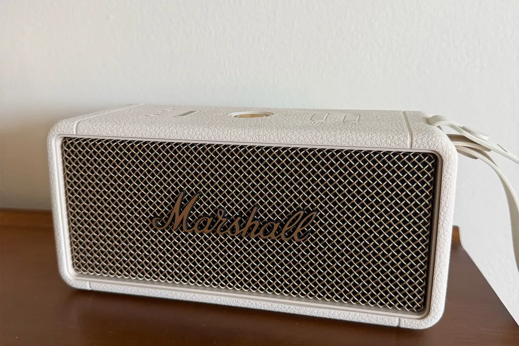 White Marshall bluetooth speaker on a wooden surface.