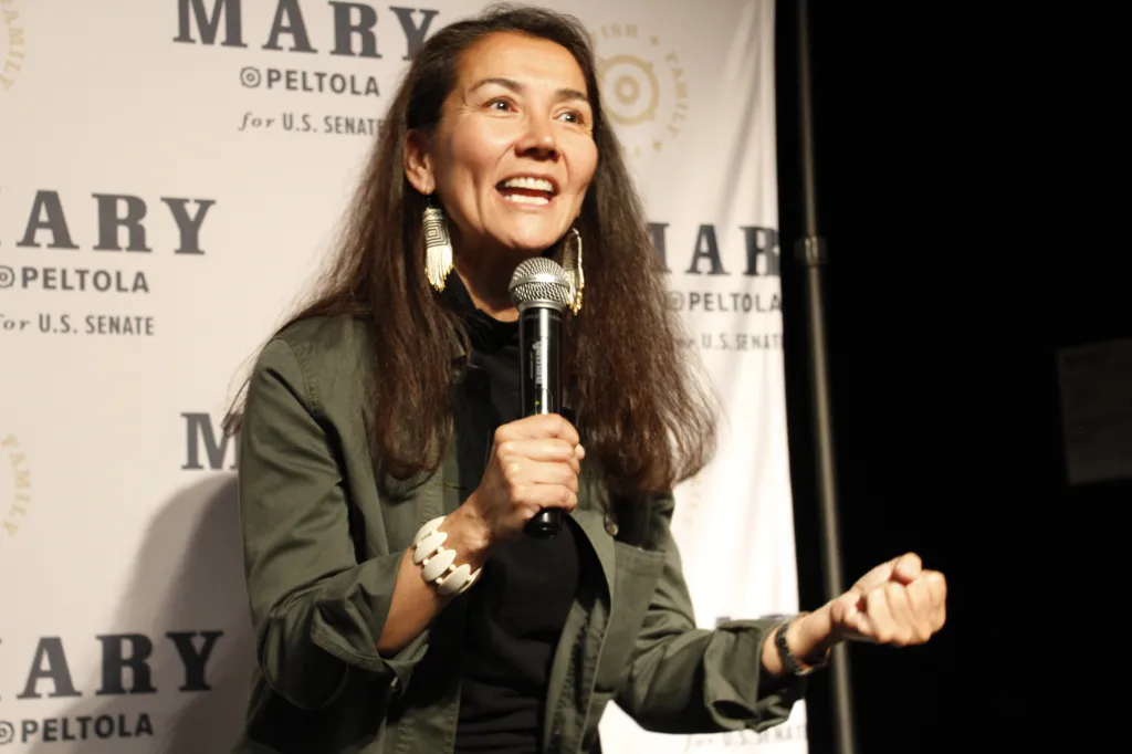 Mary Peltola, a Democrat running for the U.S. Senate seat in Alaska, speaks into a microphone at an election watch party.