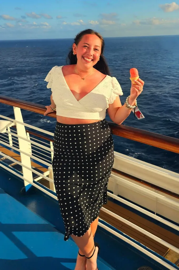 Chea Eagleson holding a popsicle on a cruise ship.