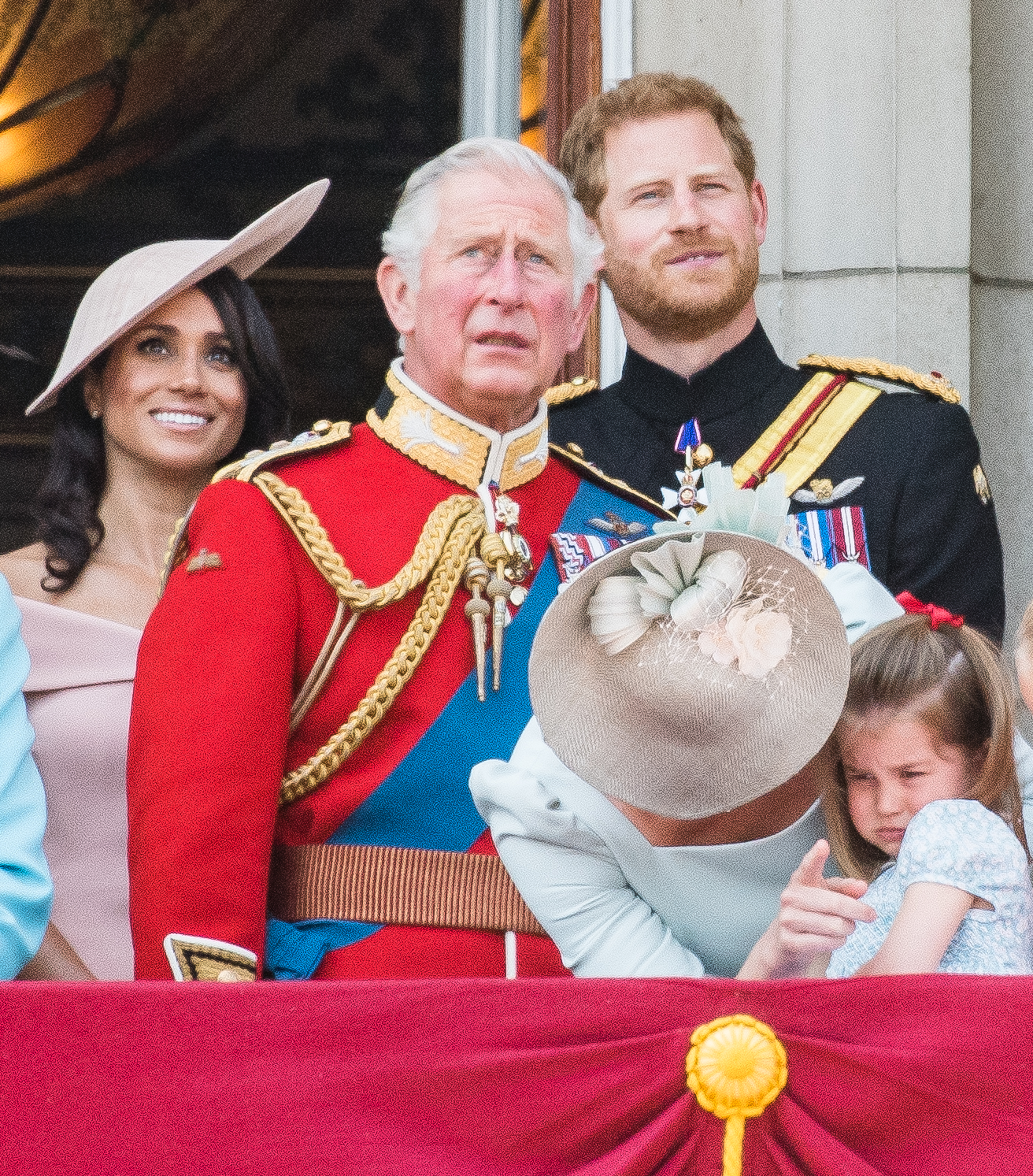 Meghan Markle, Prince Charles, Prince Harry, Kate Middleton, and Princess Charlotte on the Buckingham Palace balcony.