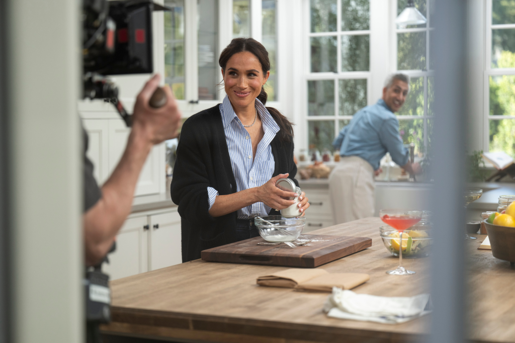 Meghan, Duchess of Sussex, and Tan France preparing food in a kitchen for 
