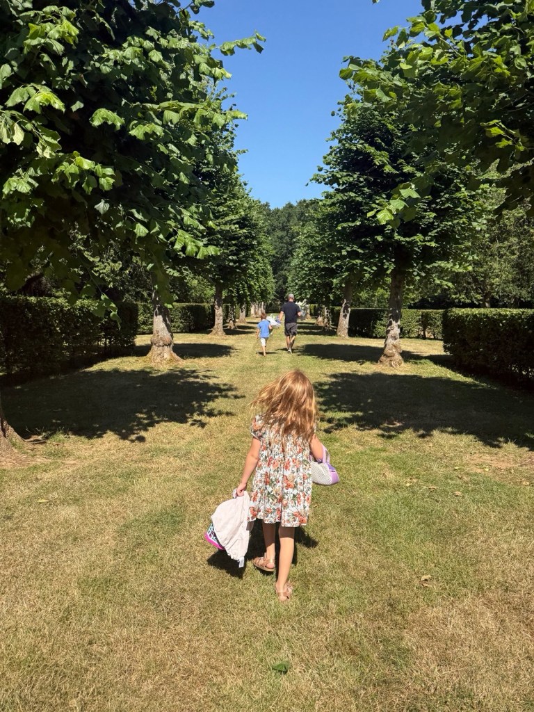 Princess Lilibet, in a floral sundress, runs at Althorp.