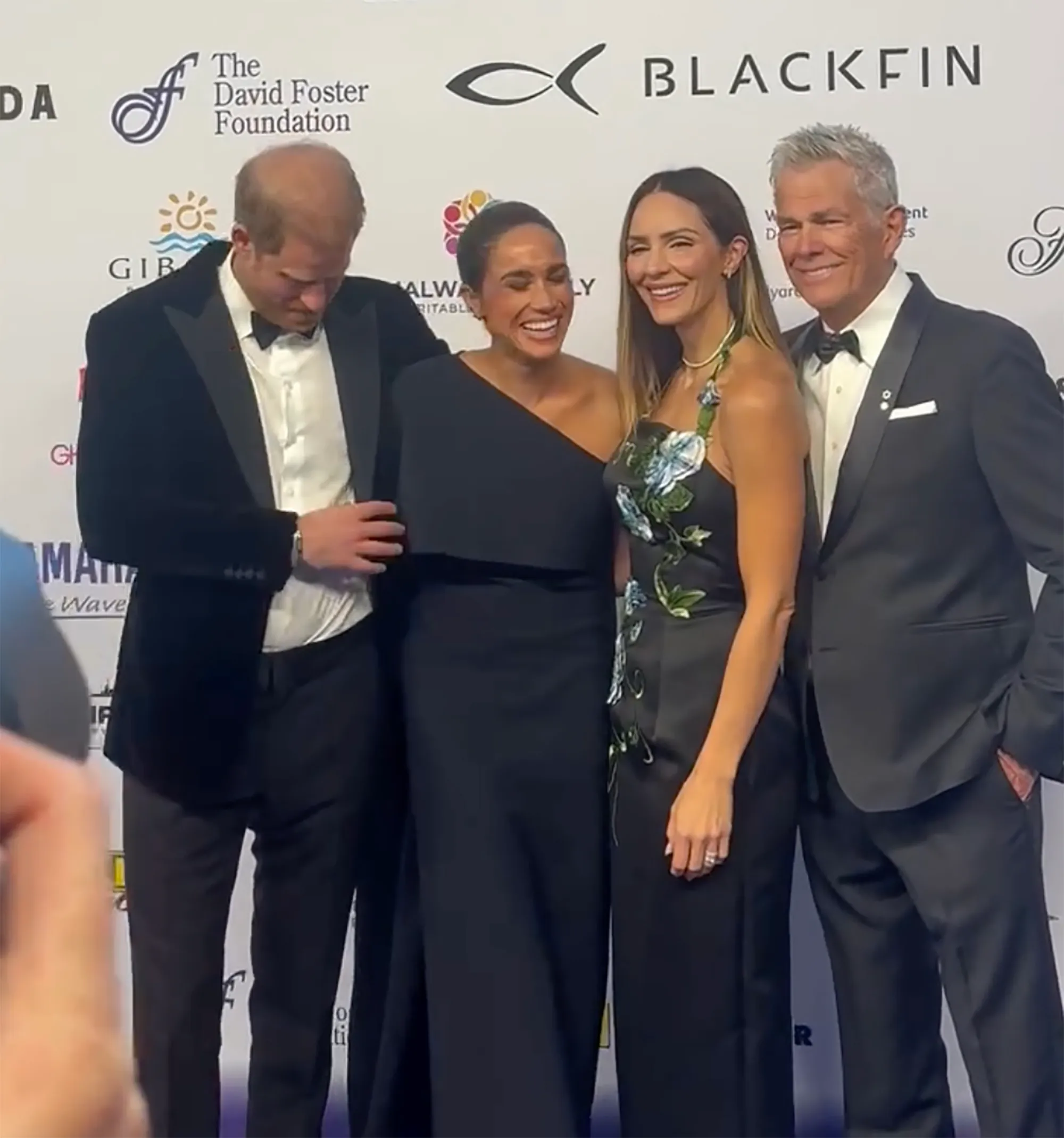 Prince Harry, Meghan Markle, Katharine McPhee, and David Foster posing for a picture at The David Foster Foundation event.