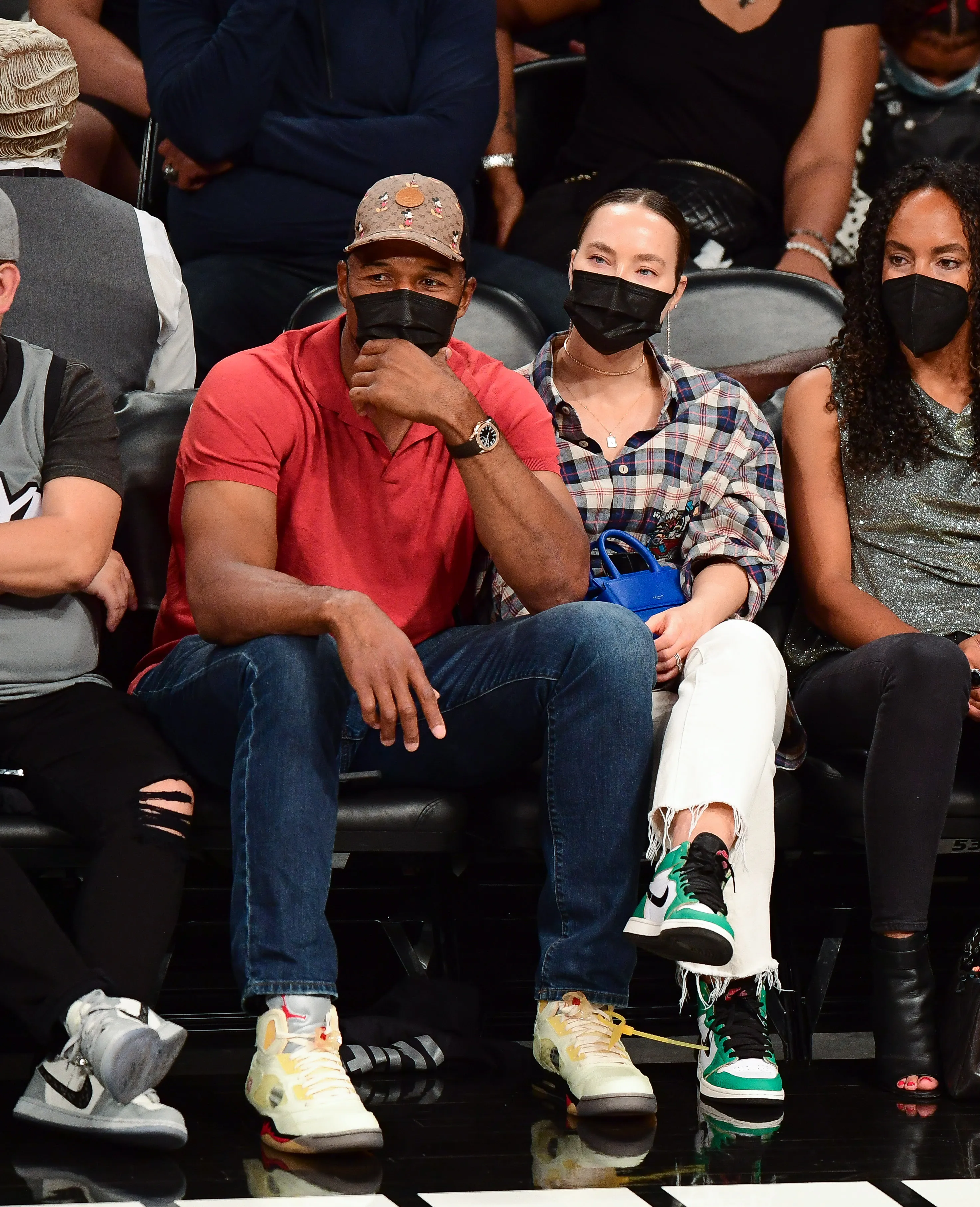 Michael Strahan and Kayla Quick watch a Brooklyn Nets vs. Boston Celtics game.