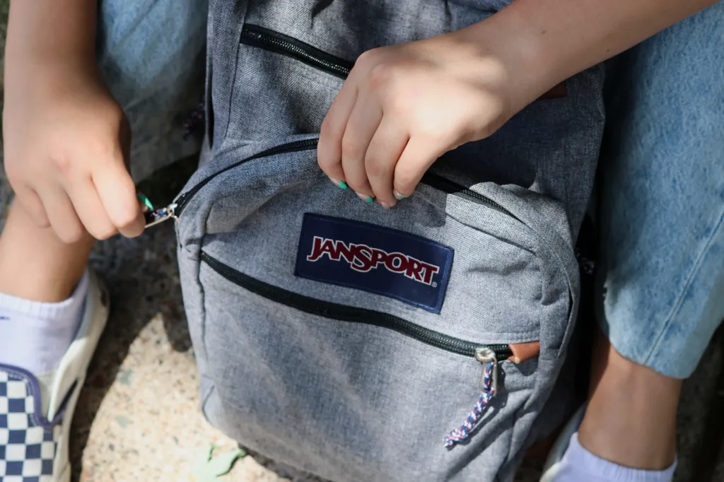 Claire Knoth zipping up her backpack.