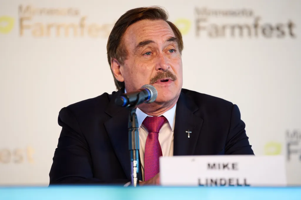 Mike Lindell speaks into a microphone at a candidate forum.