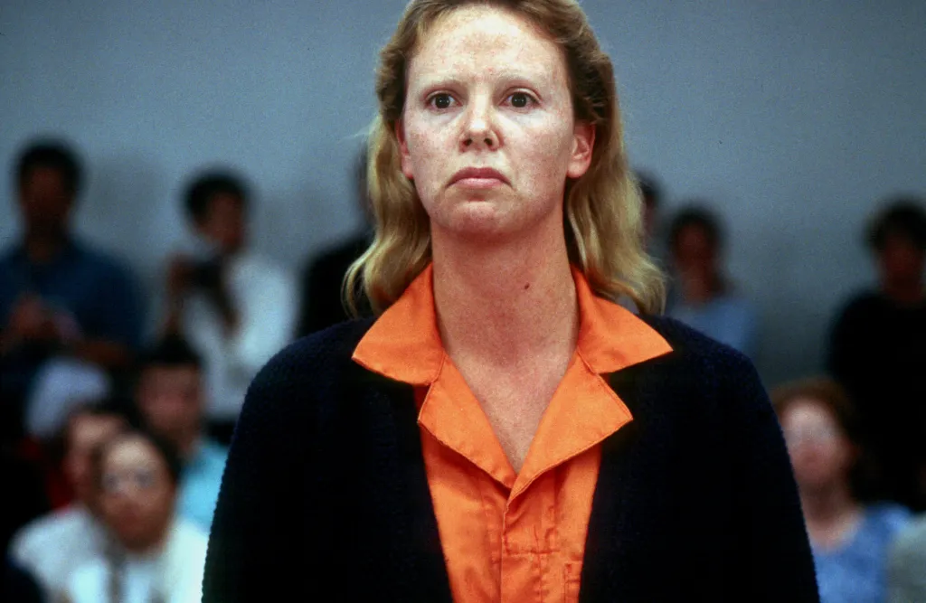 Charlize Theron as a defendant in a courtroom scene from the film *Monster*.