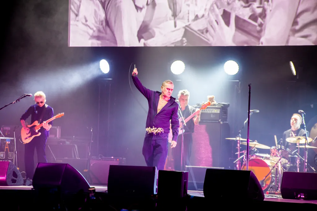 Morrissey performing on stage during his European tour with bandmates.