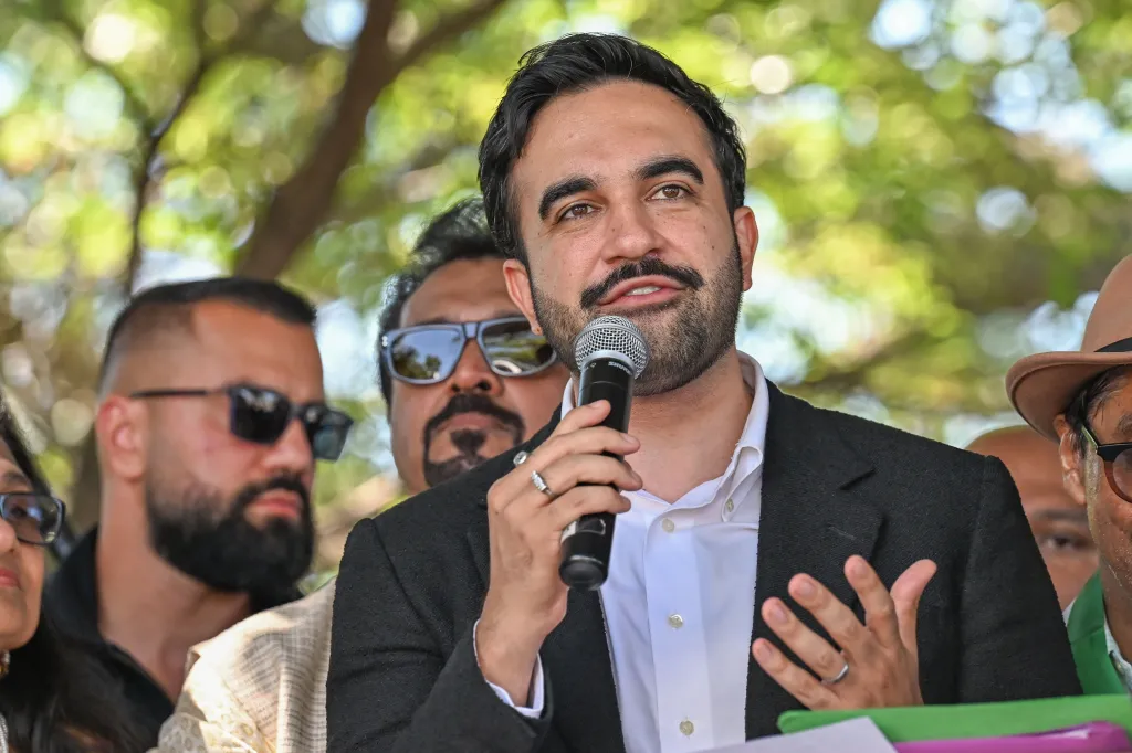 New York City Council Member Zohran Mamdani speaking into a microphone.