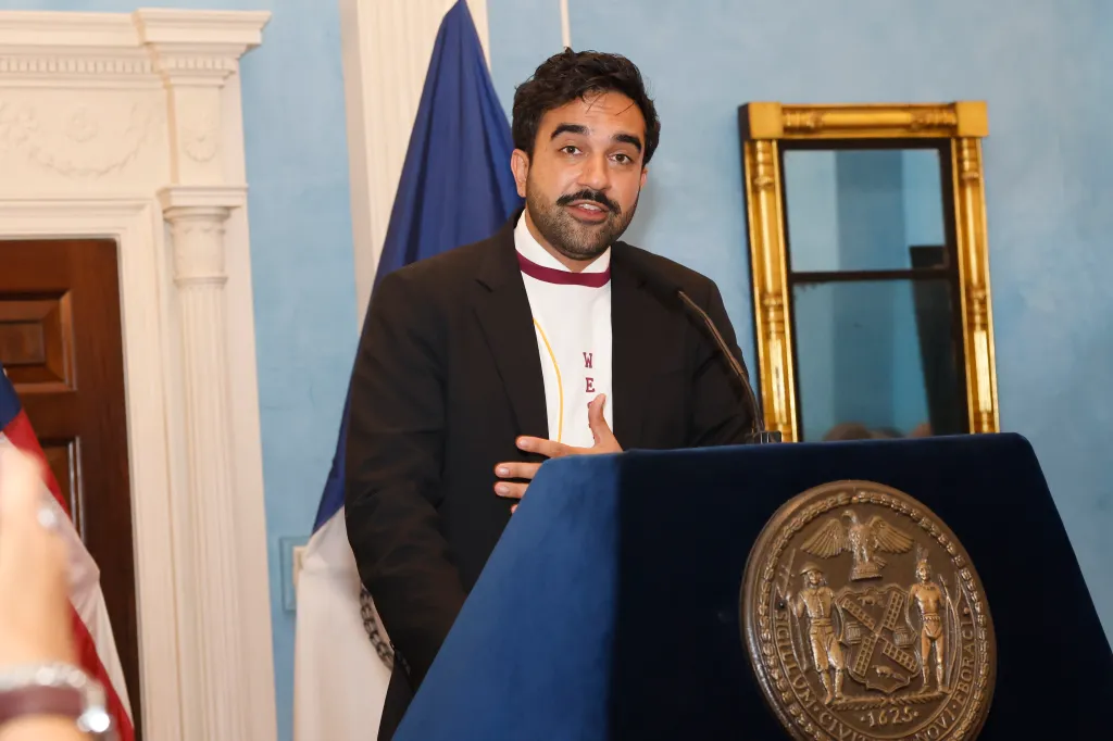 New York City Mayor Zohran Kwame Mamdani speaks at a podium.