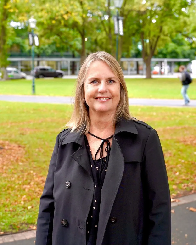 Dunedin City Councillor Jo Galer smiling in front of a park.