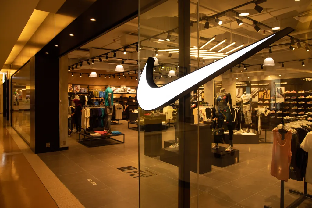 The Nike logo is prominent on the storefront of a Nike store in Kuala Lumpur, Malaysia.