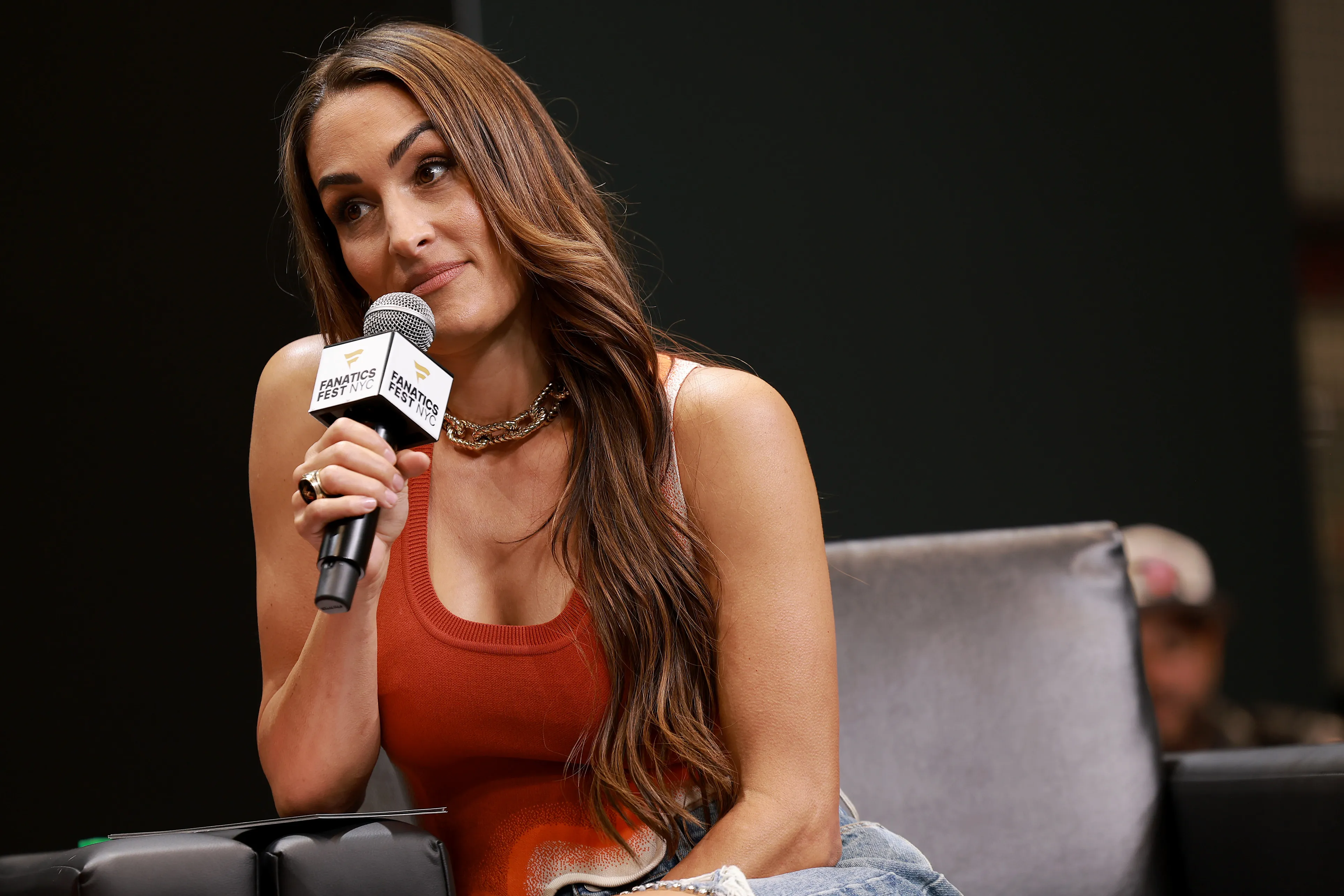 Nikki Bella speaks into a microphone at Fanatics Fest.