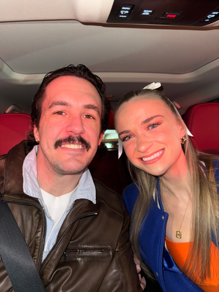 Jason Henley and Hannah Alderman smile for a selfie in a car.