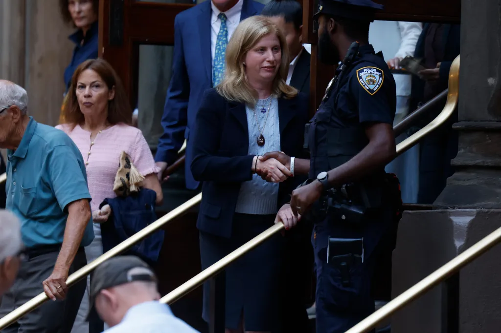 NYPD Commissioner Jessica Tisch shakes hands with a police officer.