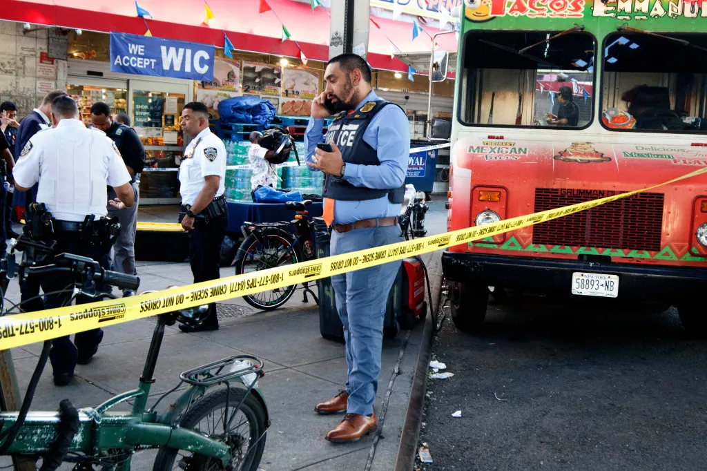 NYPD officers at the scene of a stabbing in the Soundview neighborhood of the Bronx, with yellow crime scene tape visible.