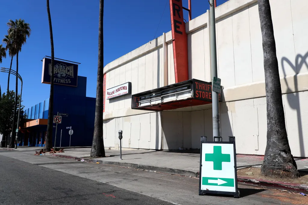 A derelict movie theater on Van Nuys Boulevard with boarded-up storefronts and a