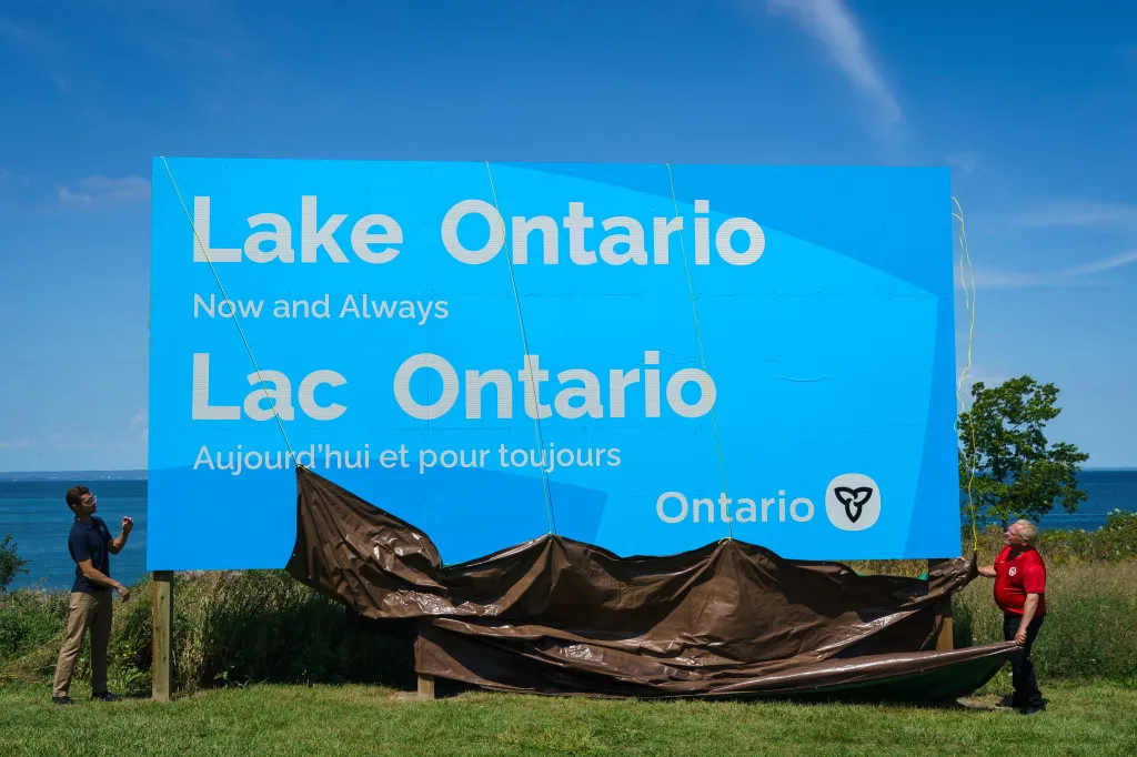 Sam Oosterhoff and Doug Ford unveil a sign for Lake Ontario.