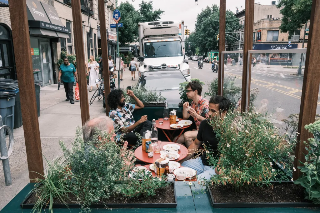 Outdoor dining structure at Lowerline, a Cajun restaurant in Prospect Heights, Brooklyn, with customers enjoying a meal.