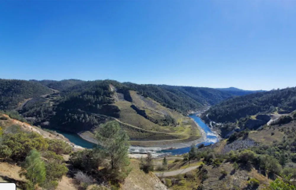 The American River Canyon with a river winding through hills.