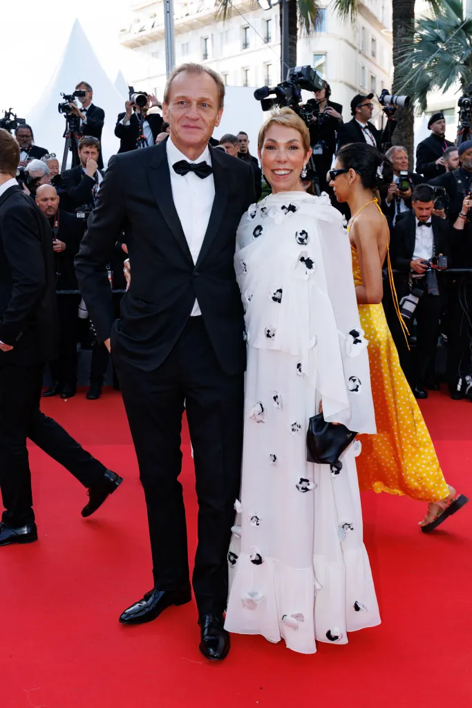 Mathilde Favier and Nicolas Altmayer posing on a red carpet.