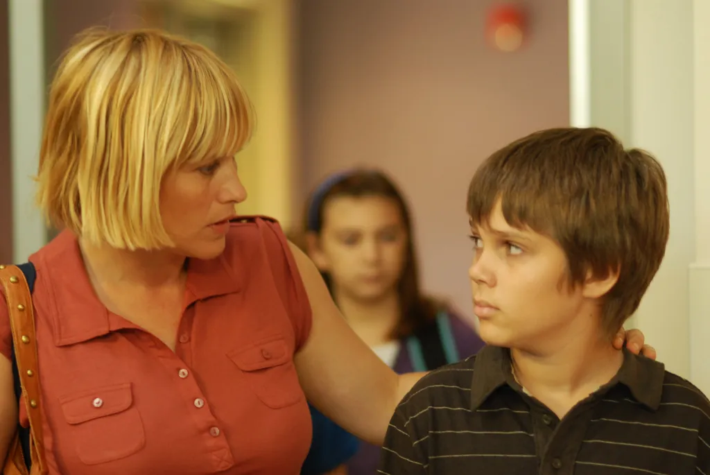Patricia Arquette with her hand on Ellar Coltrane's shoulder in 