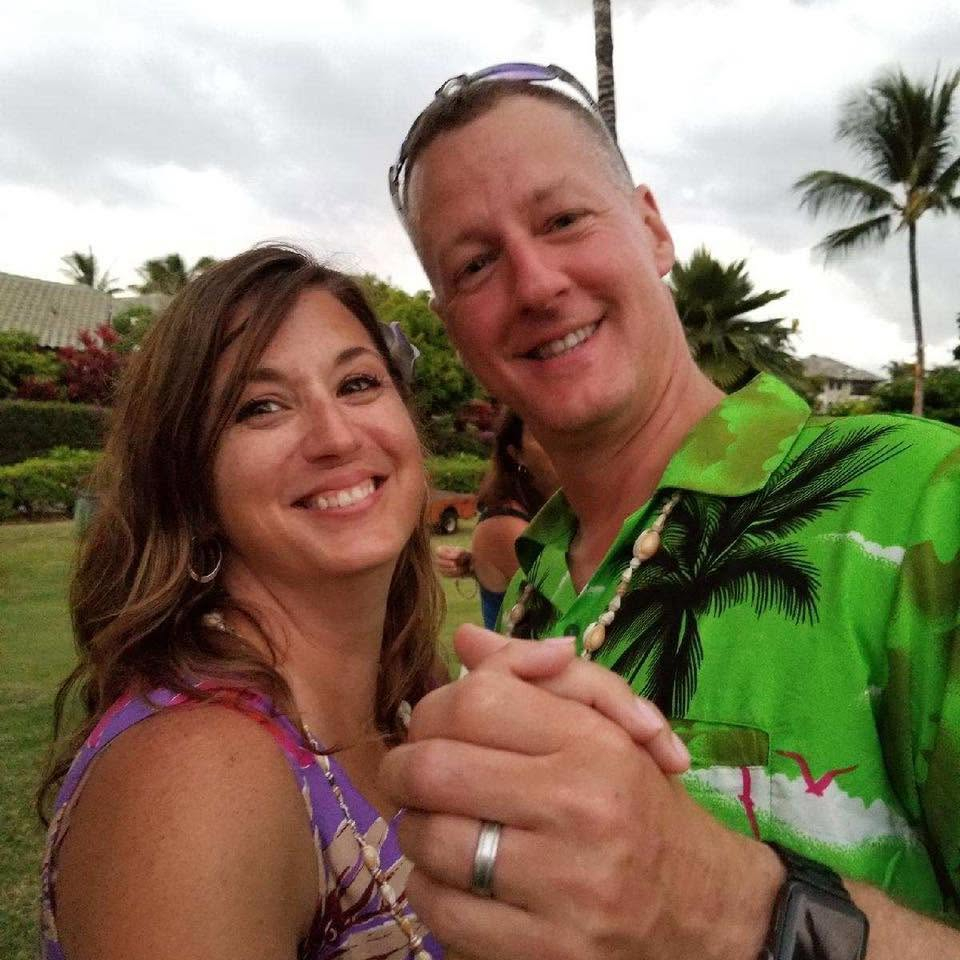 Paul Robinson and his wife Laura Nee-Robinson holding hands.