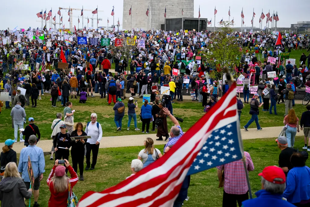 People gather on the National Mall to protest policies of the Trump administration, as well as Elon Musk's influence, in one of over a thousand rallies scheduled nationwide under the slogan 