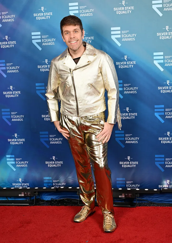 Perez Hilton on the red carpet wearing a gold motorcycle jacket and gold pants.