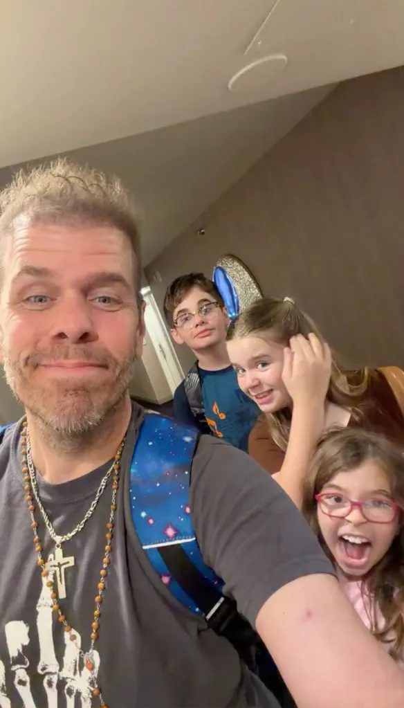 Perez Hilton taking a selfie with his three kids.