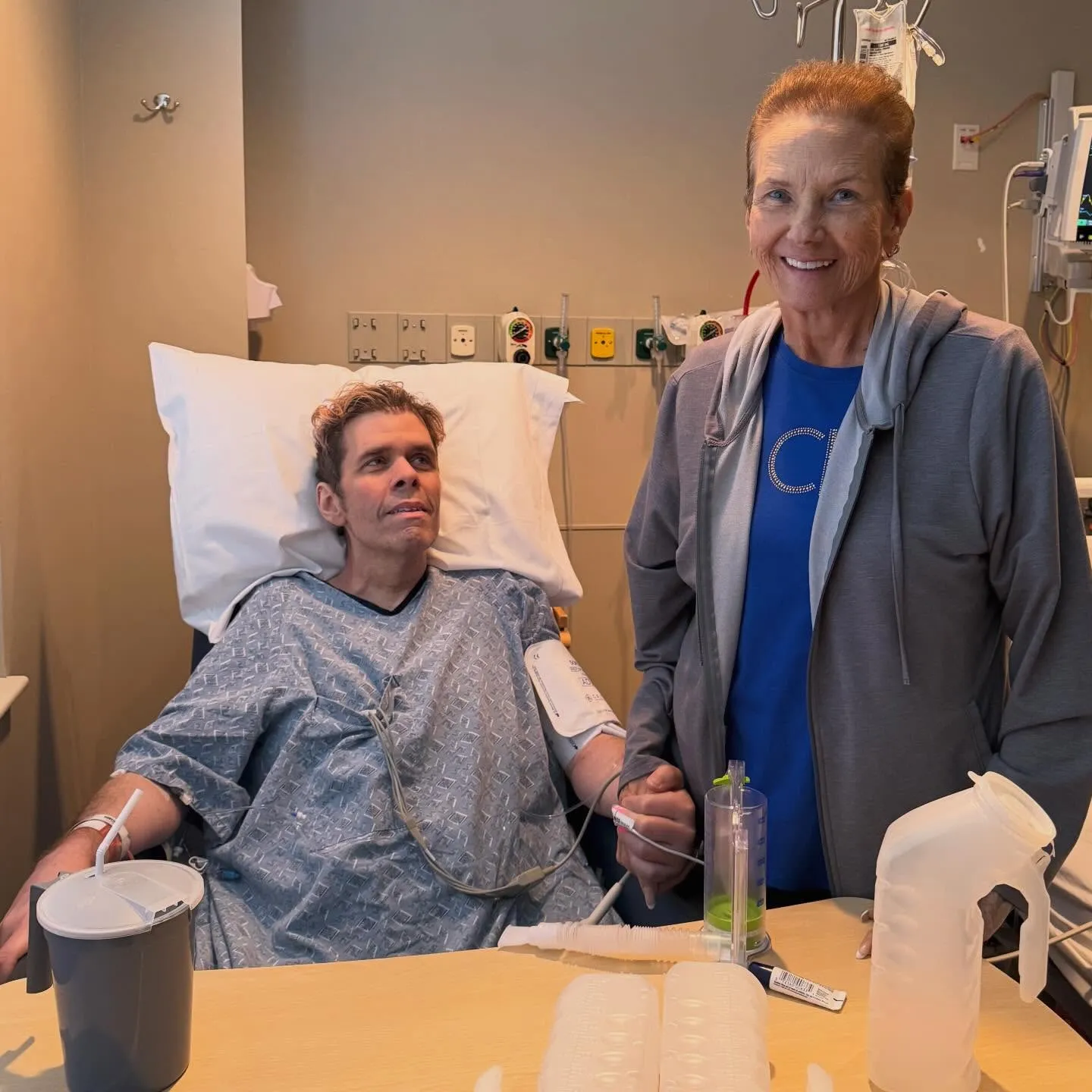 Perez Hilton and his mother Teresita in a hospital room.