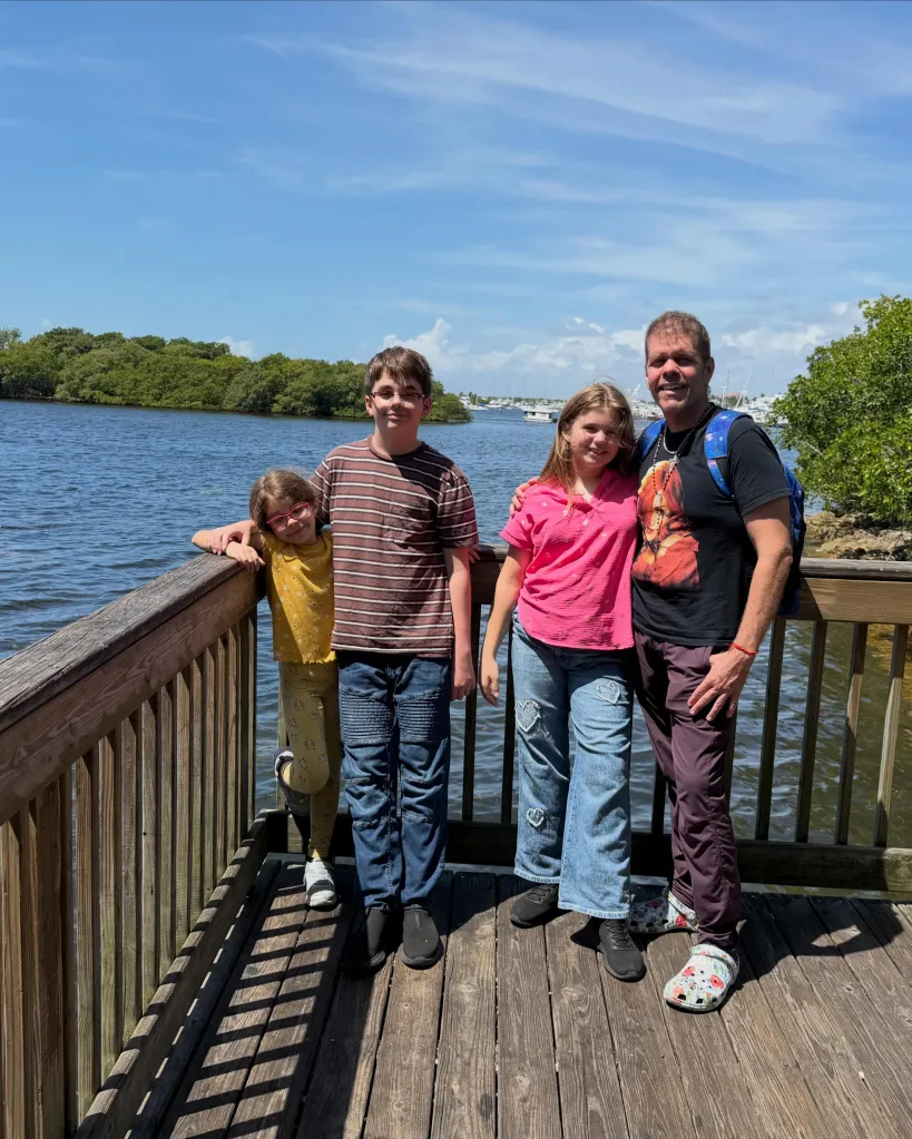 Perez Hilton with his three children by a lake.