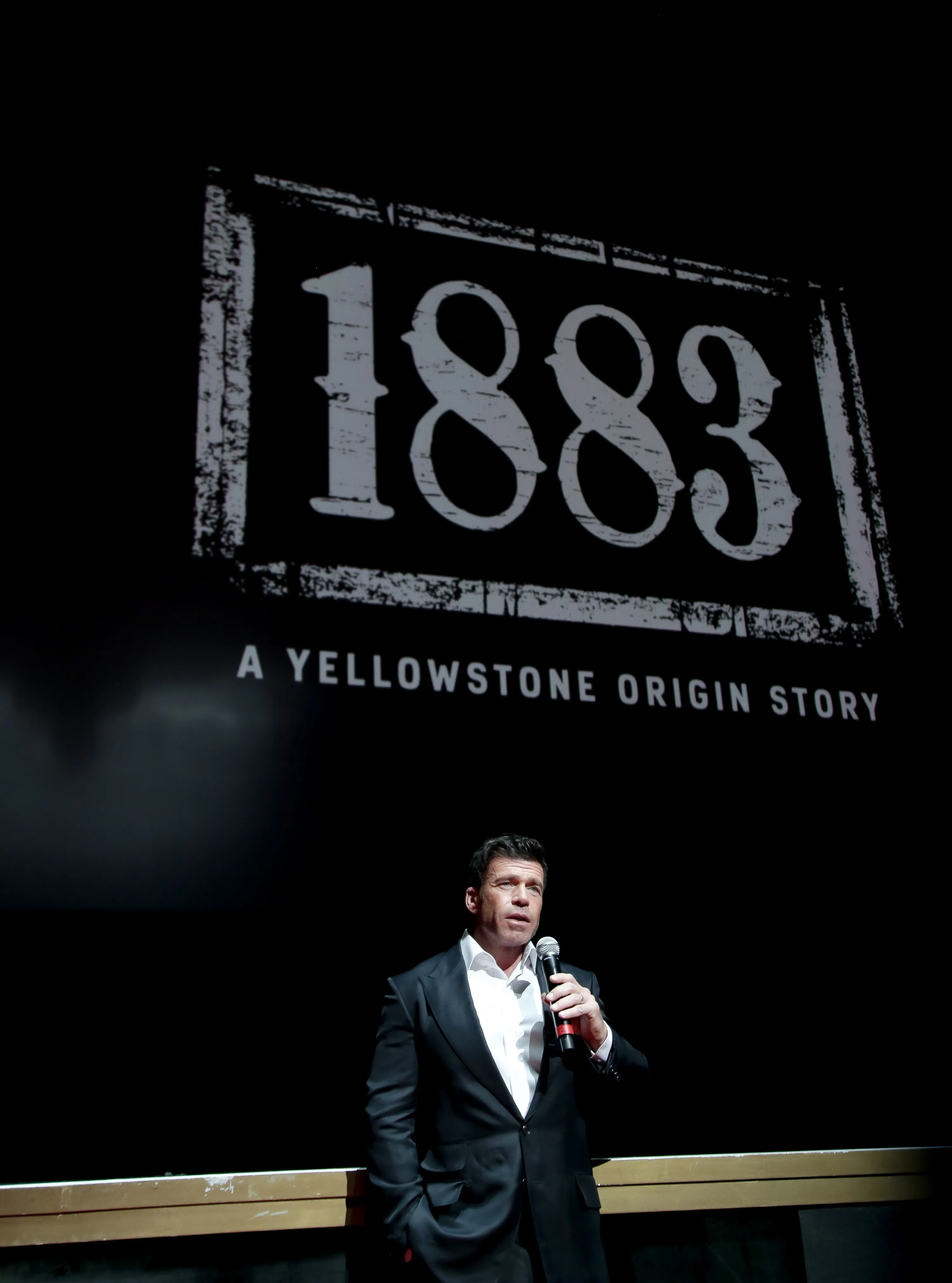 Taylor Sheridan speaks on stage at the premiere of
