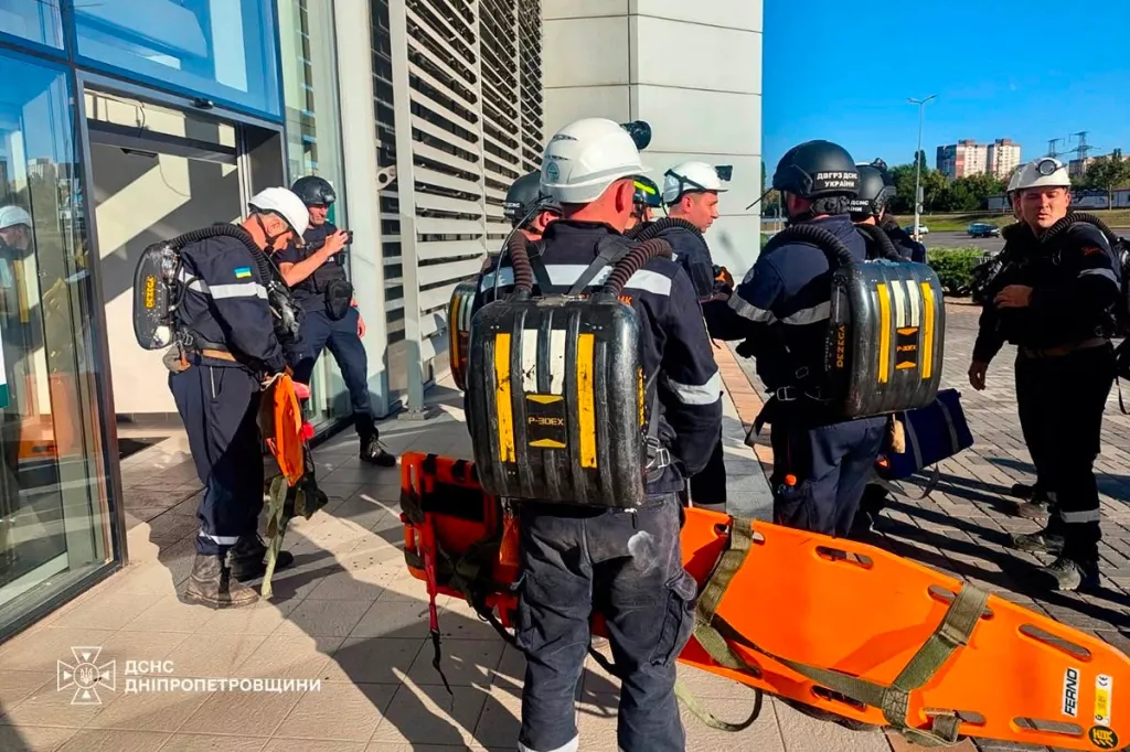 Rescuers gather outside a damaged shopping mall in Kryvyi Rih, Ukraine.