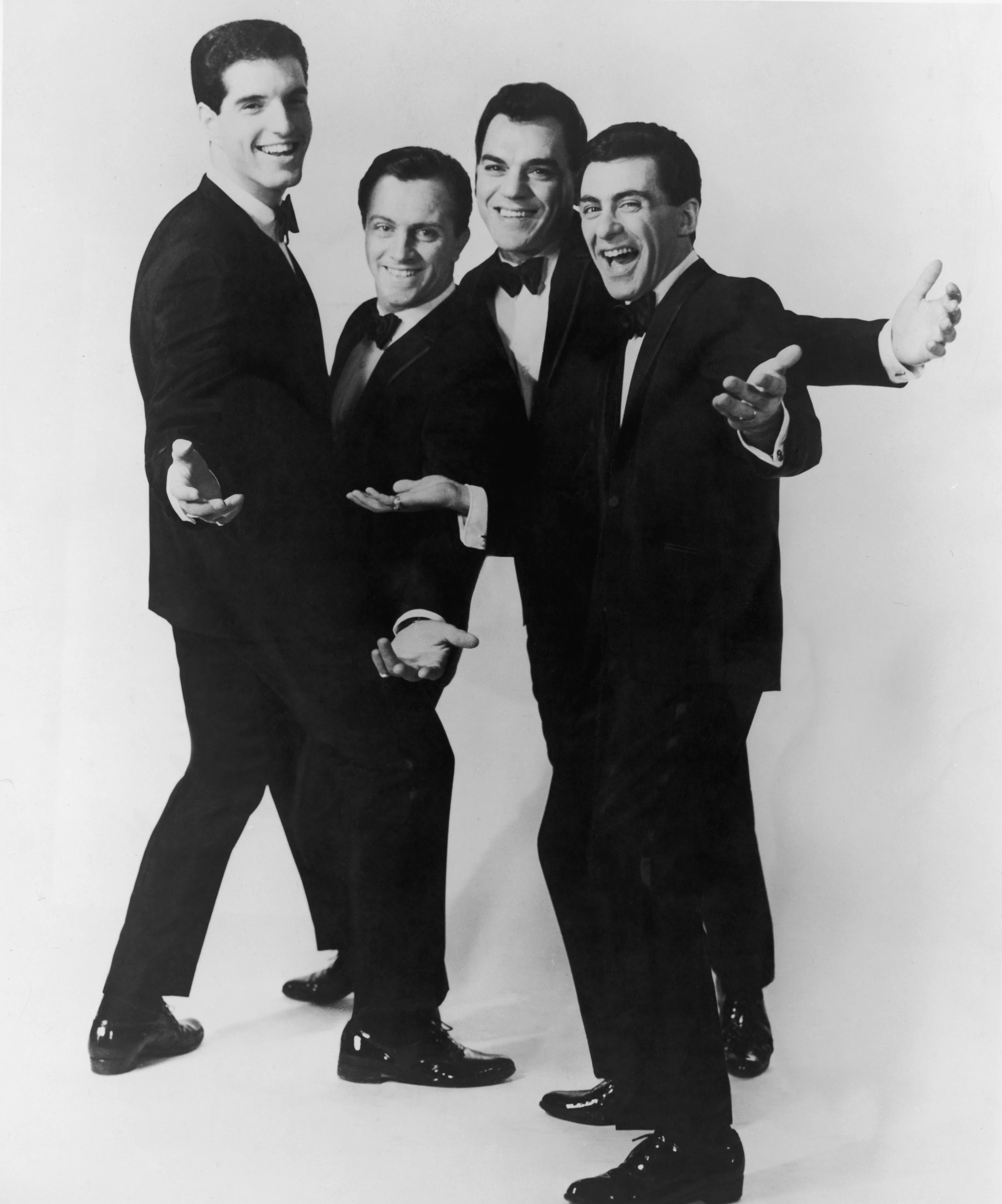 The Four Seasons vocal group in black suits.