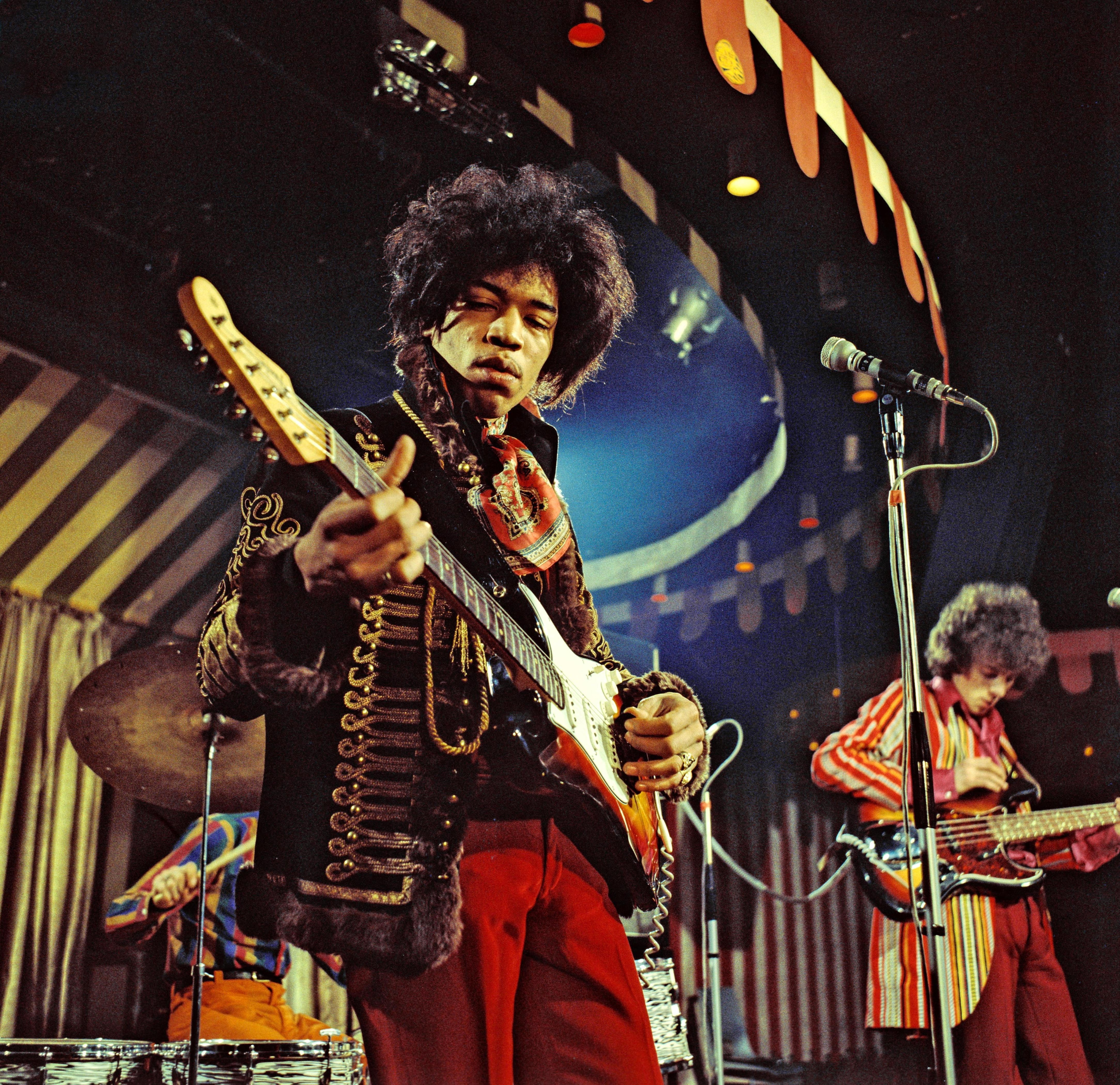 Jimi Hendrix performing on stage with a guitar at the Marquee Club in London in 1967.