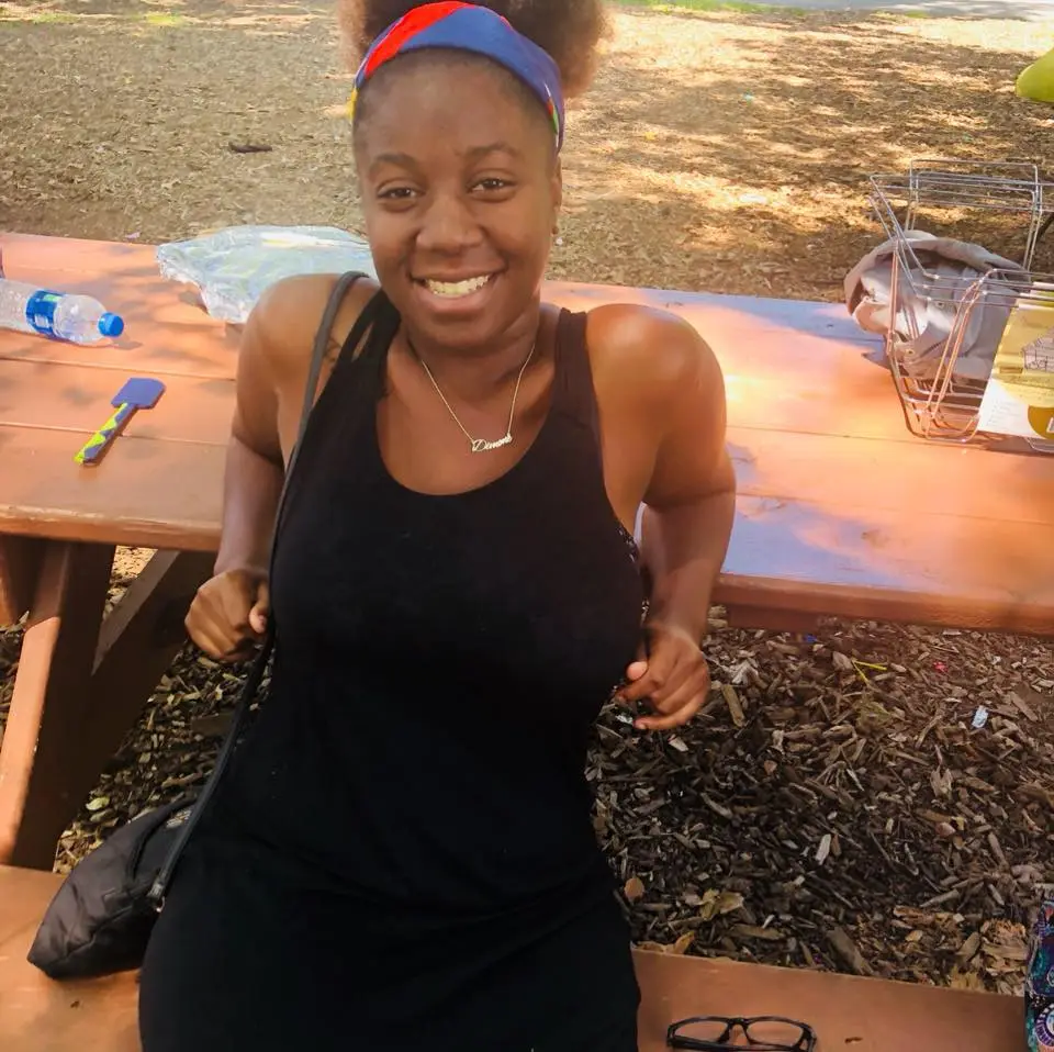 Dimone Fleming, charged with murder, sitting at a picnic table.