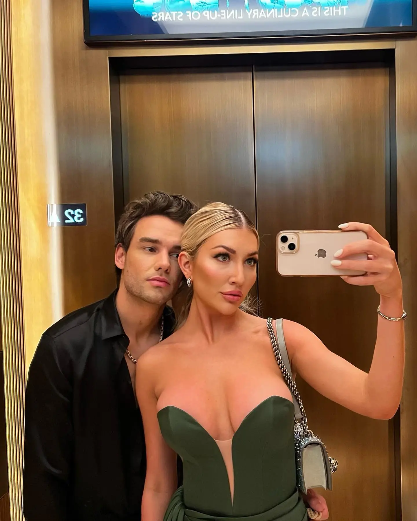 Liam Payne and Kate Cassidy posing for a selfie in an elevator.