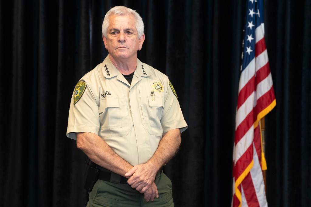 Pima County Sheriff Chris Nanos, in a khaki shirt and pants, at a press conference.
