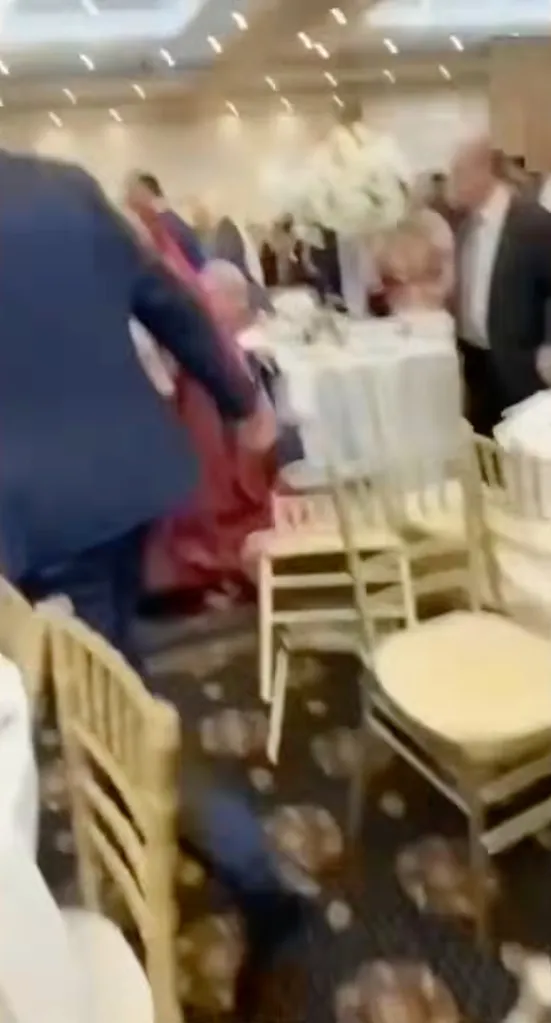 Wedding guests run outside after a brawl erupted during a celebration at the La Centre Banquet Facility in Westlake, Ohio.