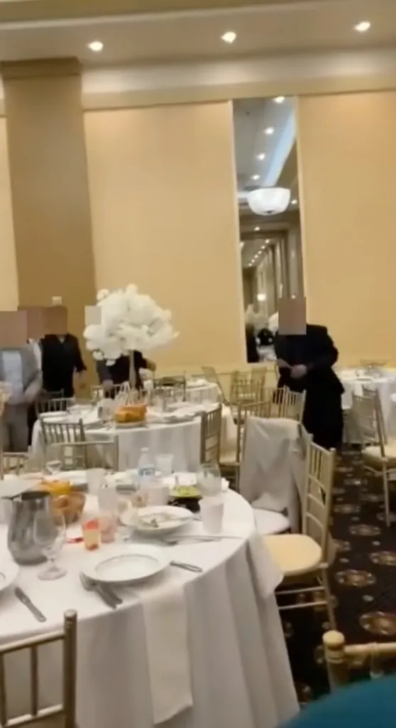 A man picks up a butter knife before charging at wedding guests inside a banquet hall in Westlake, Ohio, on Aug. 21, 2026.