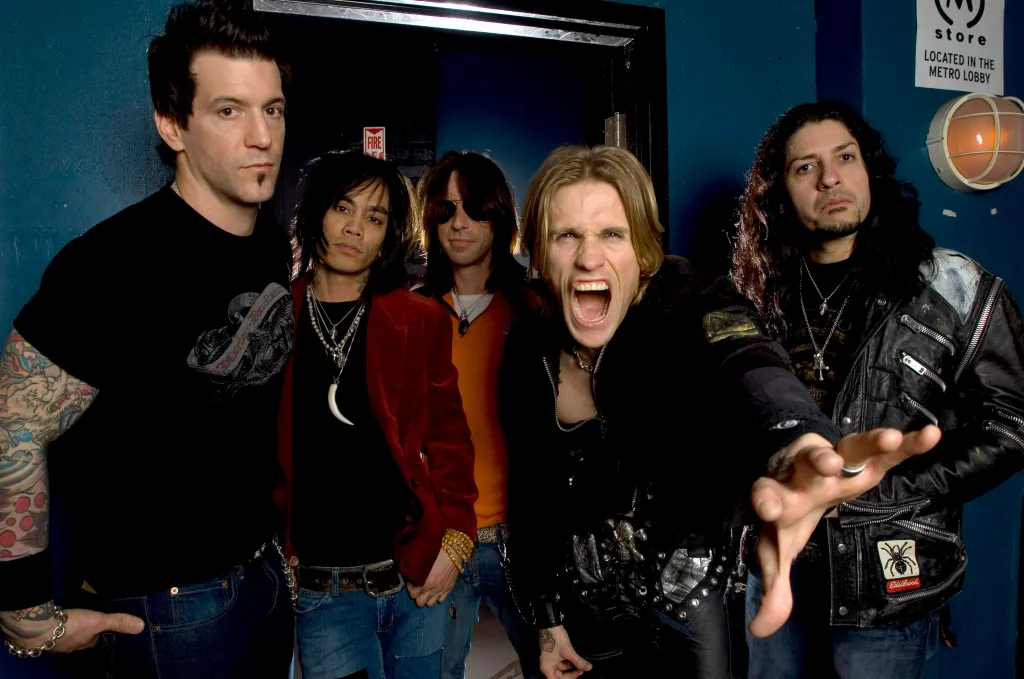 Portrait of the American rock band Buckcherry posing backstage.