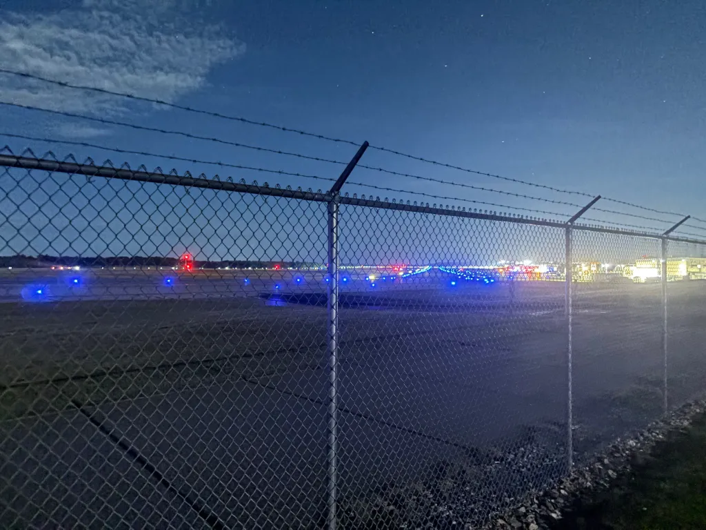 A New Hampshire airport was allegedly breached Saturday after a teenager fleeing police crashed through a perimeter fence, striking a parked plane and nearby tractor, authorities said.