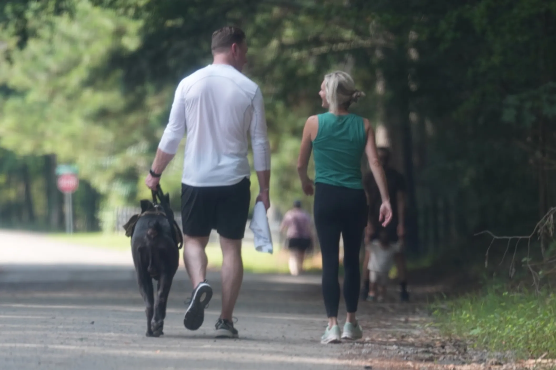 Kroy Biermann and Jillian Green hiking with a dog in Alpharetta, Georgia.